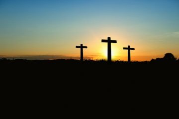 Cross in front of sunset.