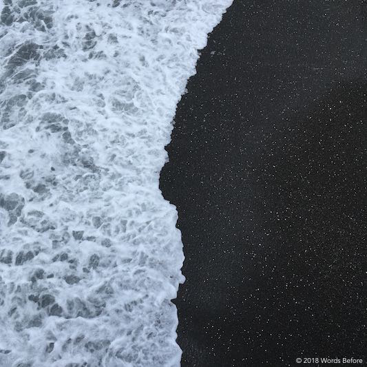 Ocean washing on to stony beach.