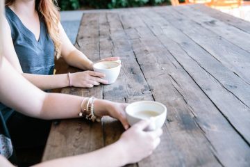 Two people talking over coffee.